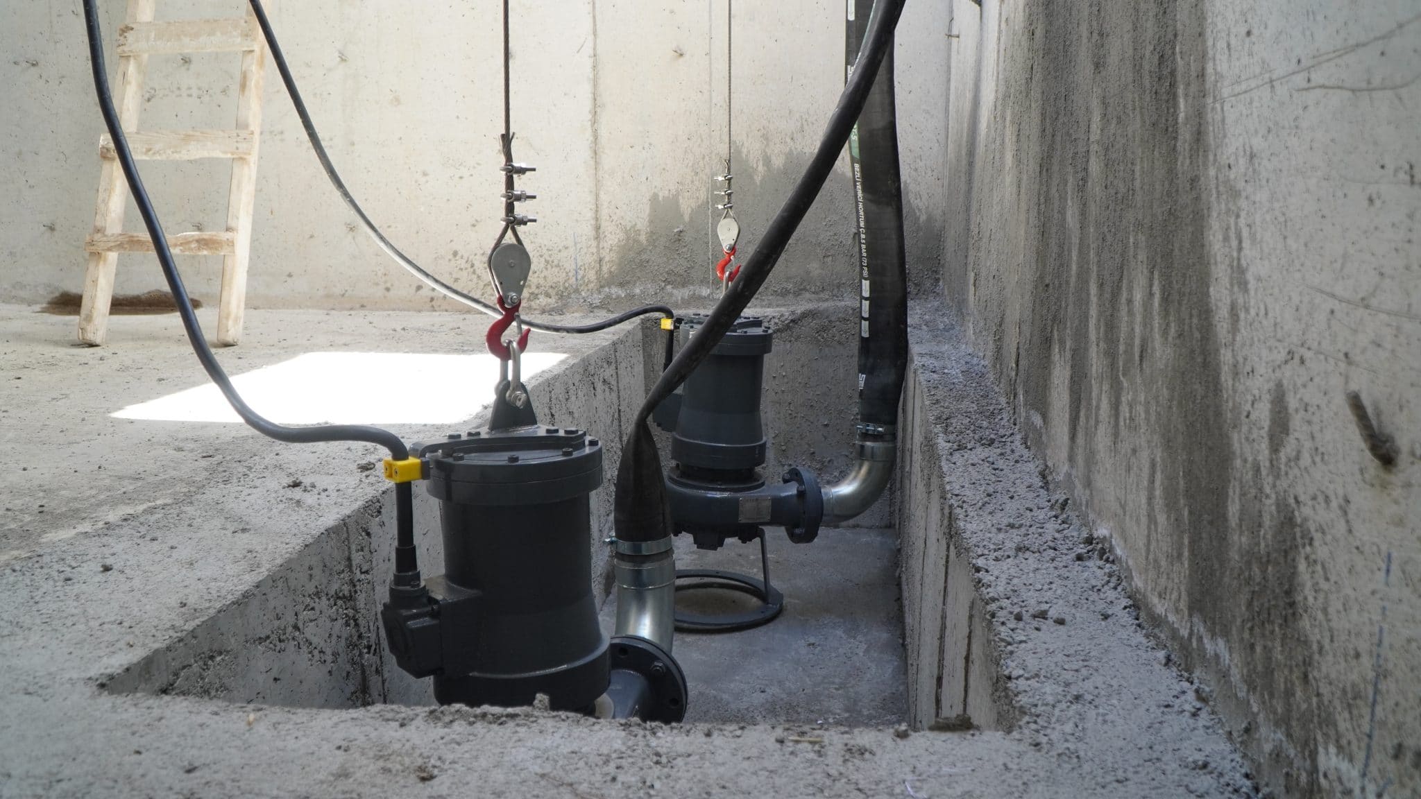 Water pump system installed in a concrete agricultural setting.