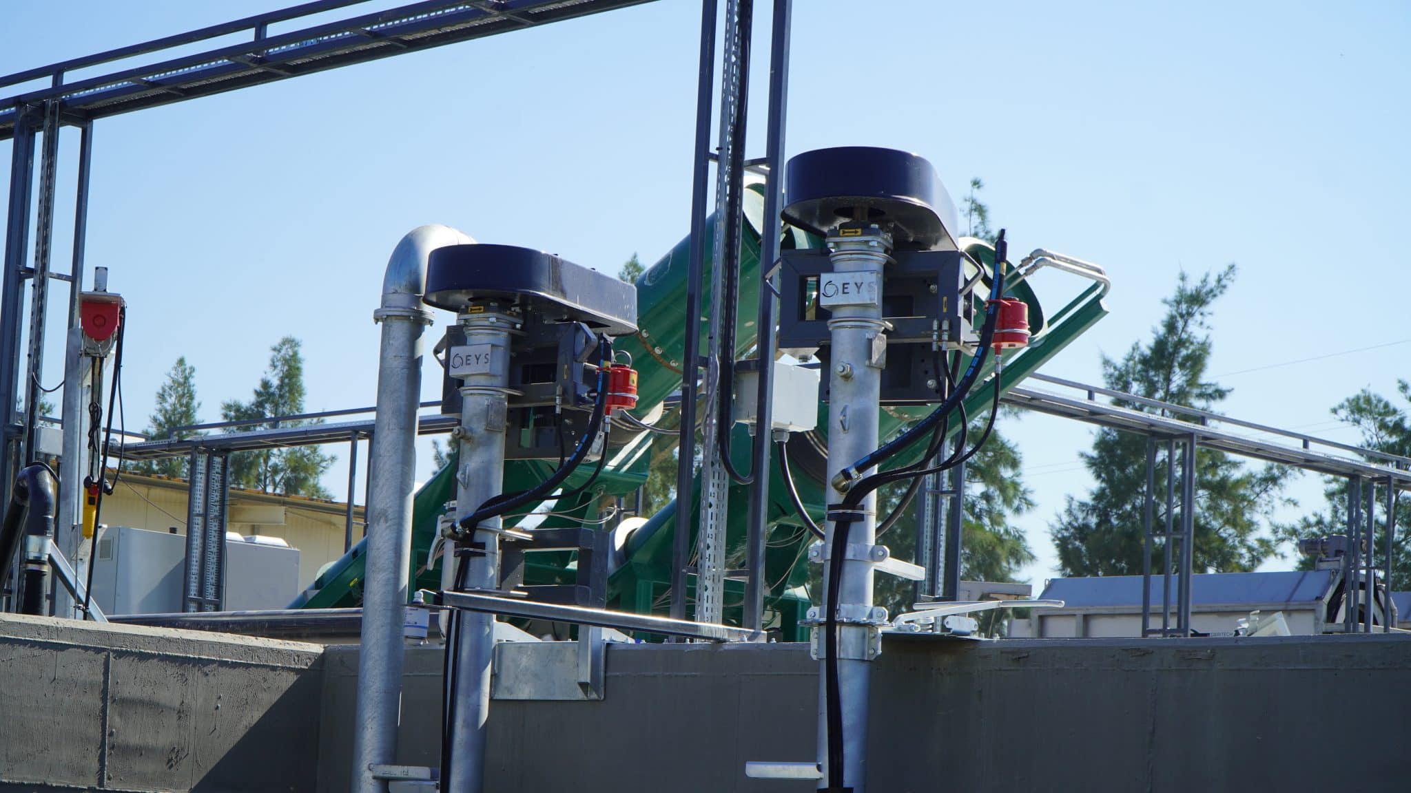 Agricultural machinery with motors and piping at Agri-Pro site.