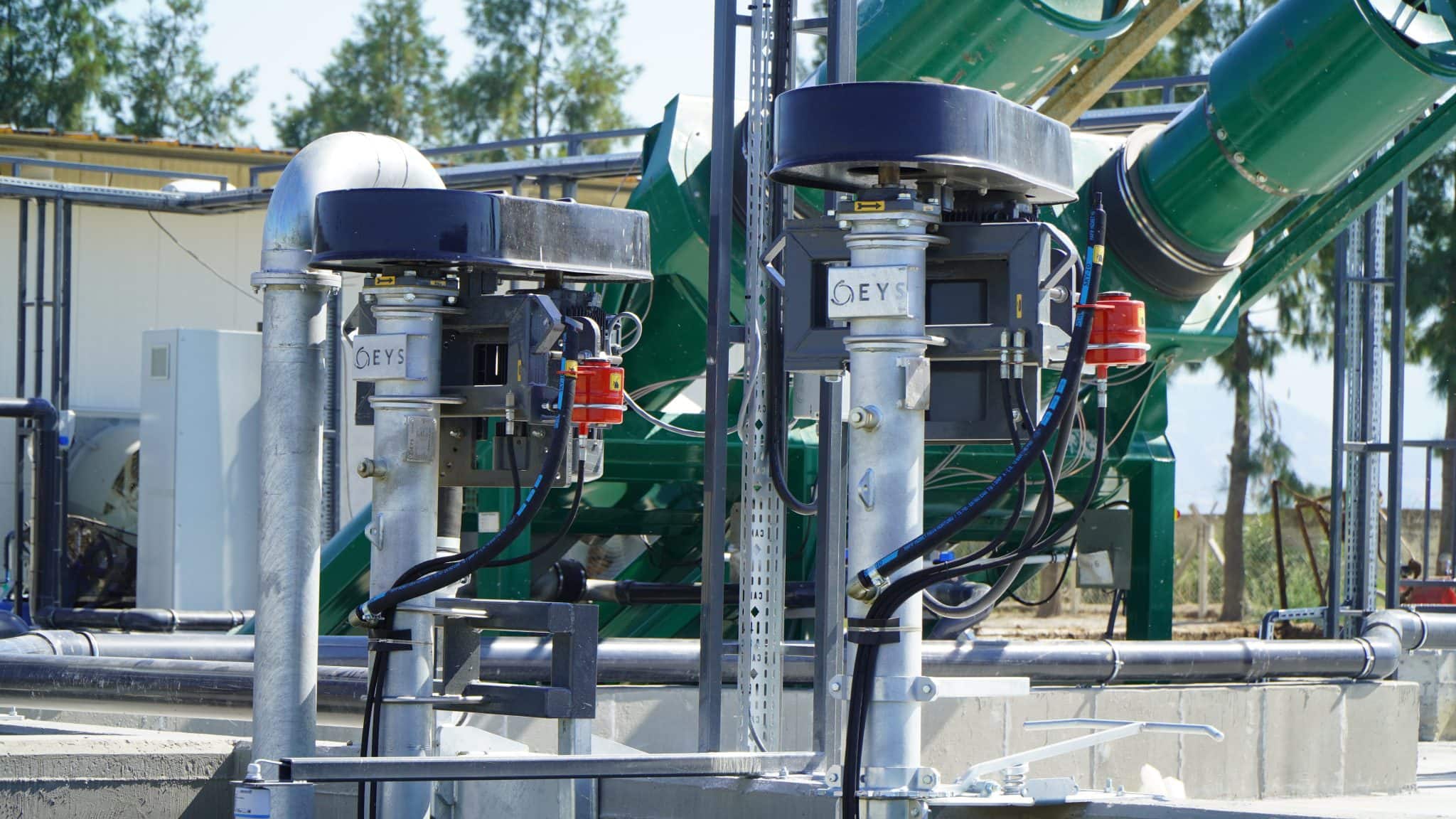 Industrial agricultural equipment with green pipes and machinery at Agri-Pro.