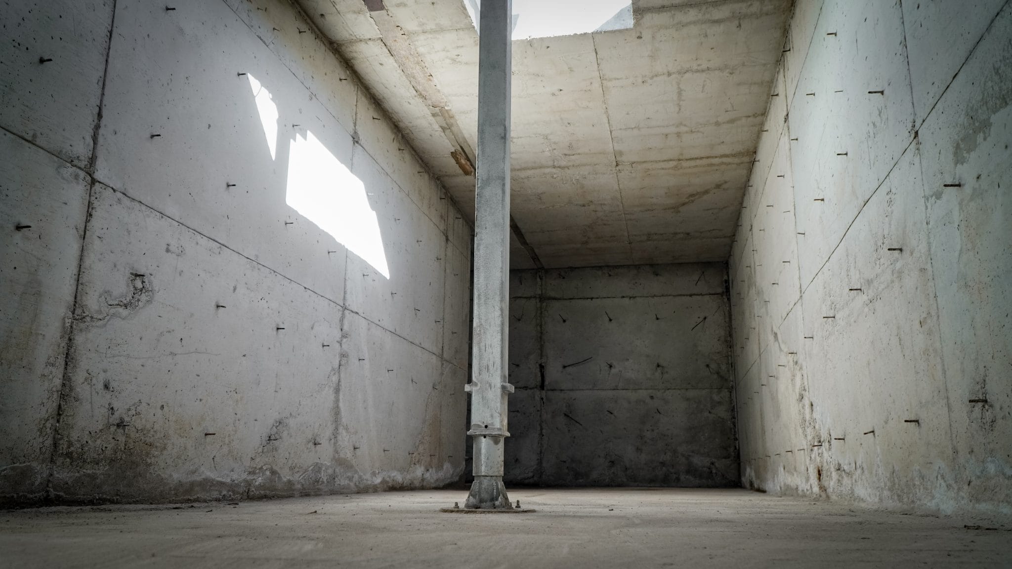 Empty concrete room with support pole at Agri-Pro New Zealand.