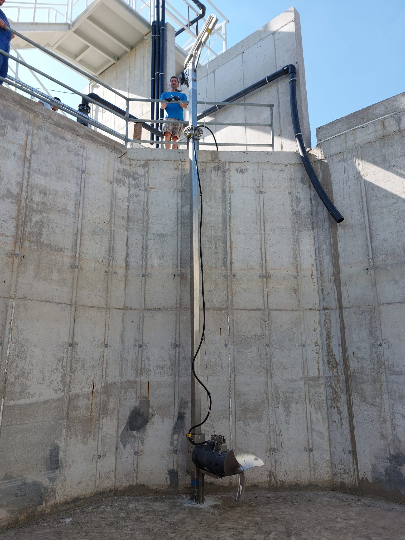 Worker inspecting industrial equipment at Agri-Pro site in New Zealand.