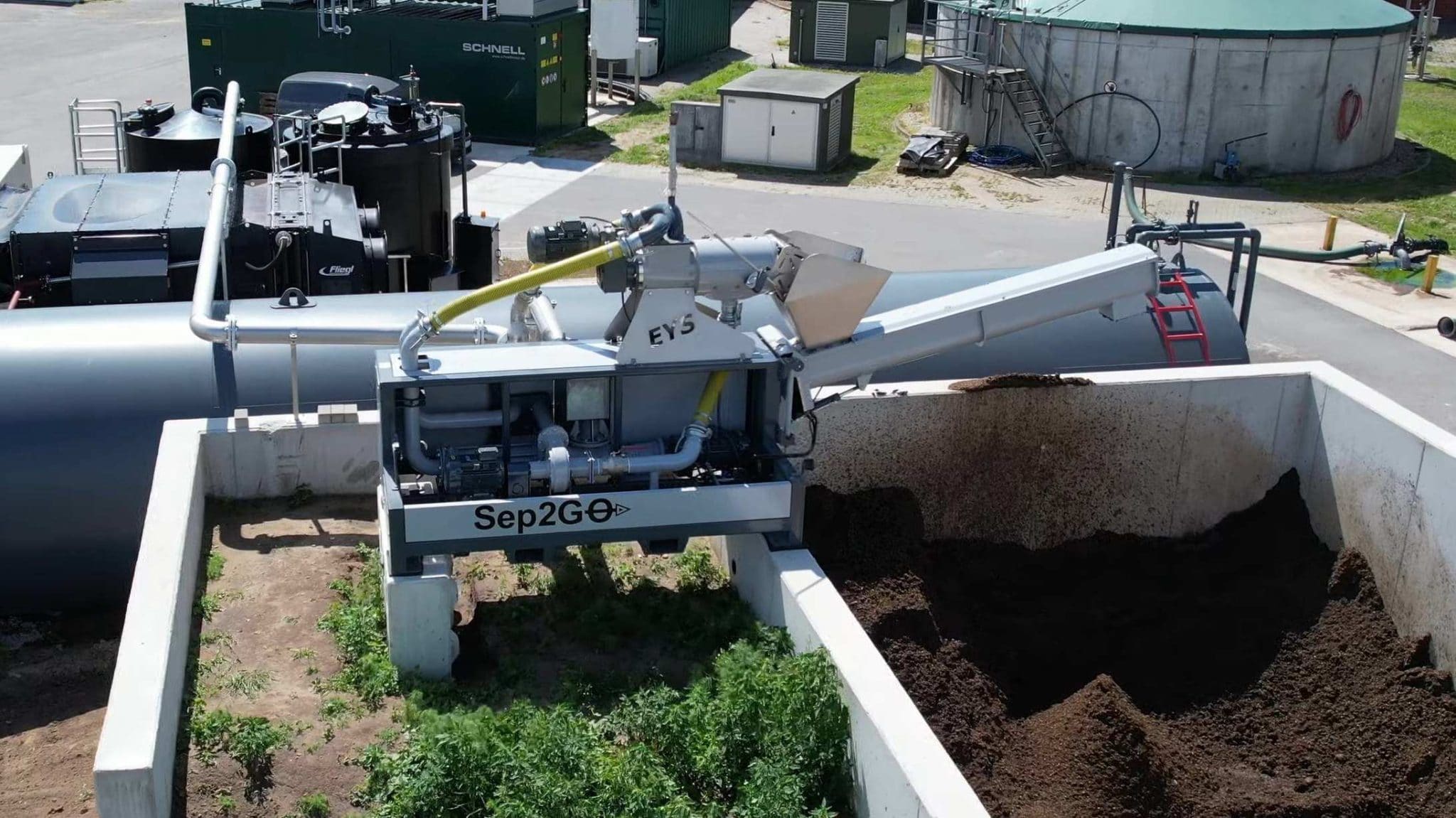 Agricultural soil processing machine at work on a farm.